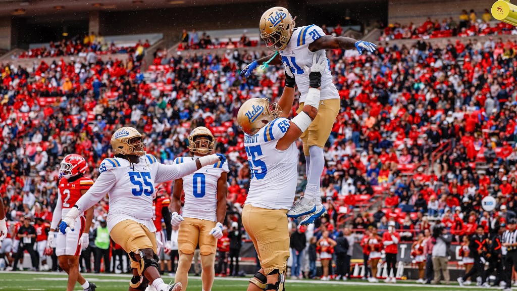 Jaivian Thomas is lifted by UCLA teammates during the win at Maryland