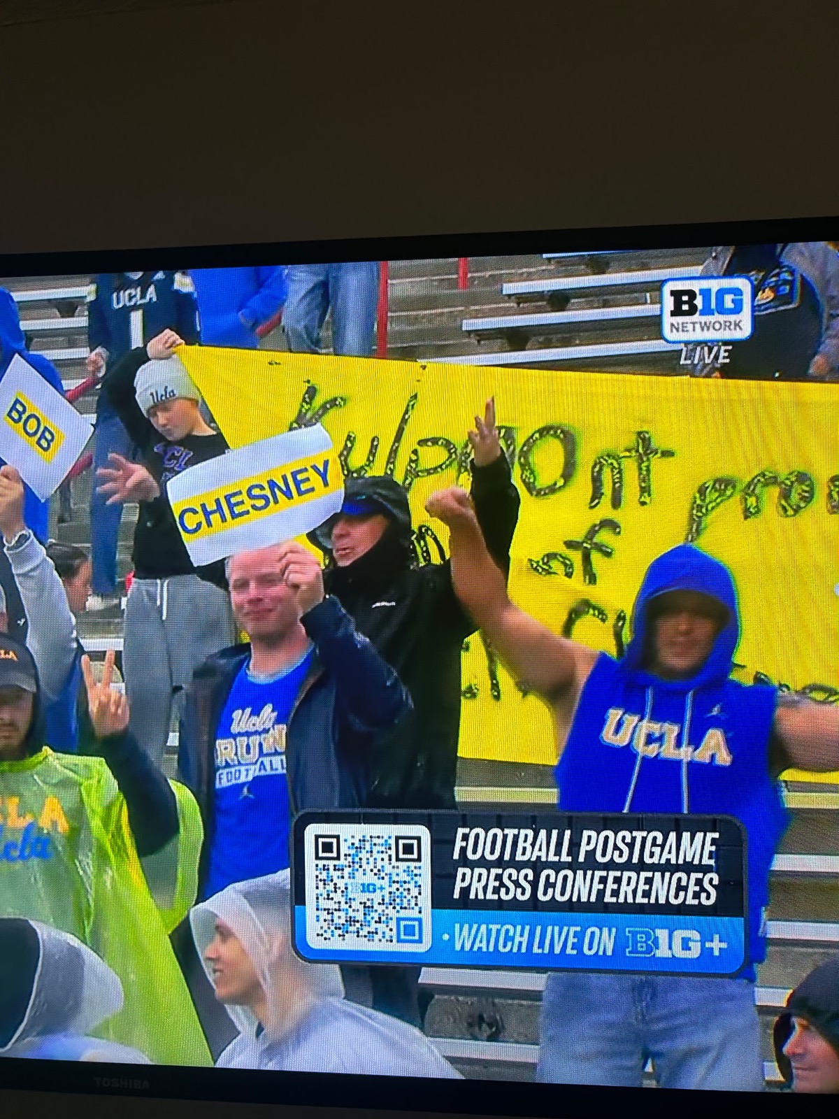 Fans holding Bob and Chesney signs in the stands at Maryland